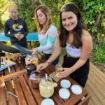 students mixing herbs smiling at camera for gift cards